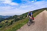 Mature man riding bike on hilly areas