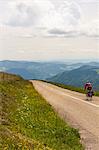 Man riding bike against mountain range