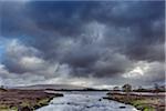 River in moor landscape with dark storm clouds at Rannoch Moor in Scotland, United Kingdom