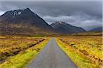 Road with mountains in the highlands at Glen Coe in Scotland, United Kingdom