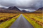 Road with mountains in the highlands at Glen Coe in Scotland, United Kingdom