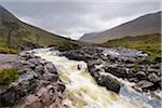 Waterfall on River Coupal with overcast sky at Glen Coe in Scotland, United Kingdom