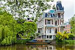 Victorian house with a classic boat along the Singelgracht canal in Amsterdam, Holland