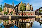 The Oude Kerk along the Oudezijds Voorburgwal canal in the city center of Amsterdam, Holland