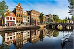 Traditional buildings and stone bridge along the Oudezijds Voorburgwal canal in Amsterdam, Holland