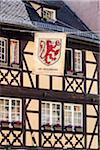 Close-up of a bakery sign hanging in front of a half-timber building in Petite France in Strasbourg, France