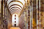 View looking down one of the aisles of the interior of the Speyer Cathedral with its stone columns and vaulted ceilings, Speyer, Germany