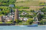 River boat travelling along the Rhine at Oberwesel with its historical watch tower, between Rudesheim and Koblenz, Germany