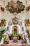 Orante alter and interior of the Roman Catholic church of Saints Peter and Paul Church in Mittenwald in Bavaria, Germany