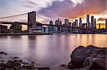 Manhattan Skyline with Brooklyn Bridge in front at dusk, New York City, long term exposure