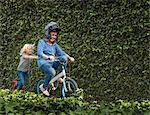 Grandson pushing grandmother on his bicycle