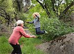 Grandson jumping off rock into grandmother's arms, Sequoia National Park, California, US