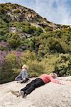 Grandson and grandmother taking break on rock, Sequoia National Park, California, US