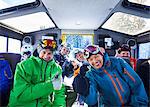 Group portrait of male and female skiers in snow coach, Aspen, Colorado, USA