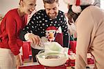 Young man and women preparing candyfloss at christmas party