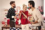 Three young friends laughing at christmas party