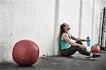 Woman taking break in cross training gym