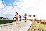 Group of friends exercising, running, outdoors, low angle view, Point Park, Miami Beach, Florida, USA
