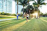 Two young women exercising outdoors, stretching, South Point Park, Miami Beach, Florida, USA