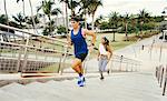 Man and woman exercising outdoors, running up steps, elevated view, South Point Park, Miami Beach, Florida, USA