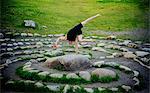 Acrobat performing on stone arrangement, Bainbridge, Washington, USA