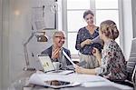 Business people planning, discussing paperwork in office meeting