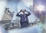 Businessman using virtual reality simulator glasses on urban street, London, UK