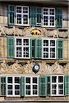 Ornate buildings with green shutters and clock in the historic ciy of Basel, Switzerland