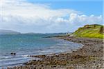Coastal landscape with lonely house on the shoreline on the Isle of Skye in Scotland, United Kingdom