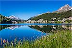 The resort town of St Moritz reflected in Lake St Moritz in the Engadin valley on a sunny day, Switzerland