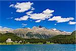 Shoreline of Lake St Moritz with the Walfhaus Hotel and the Swiss Alps in the background at the resort town of St Moritz, Switzerland