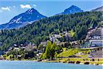 Hotels and houses along the shoreline of Lake St Moritz in the resort town of St Moritz on a sunny day, Switzerland