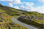 Winding coastal road and typical Scottish landscape on the Isle of Skye in Scotland, United Kingdom