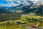 Overview of the Engadin valley with the funicular railway from Punt Muragl up to the Muottas Muragl, near St Moritz, Switzerland.