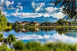 Reflections of Seefeld in Tirol in Lake Wildsee on a sunny day with the Alps in the background in Tyrol Austria