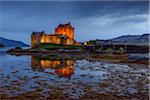 Eilean Donan Castle illuminated at dusk near Kyle of Lochalsh in Scotland, United Kingdom