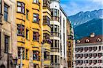 Row of traditonal buildings with the Austrian Alps in the background in Innsbruck, Austria