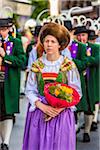 Close-up of woman and musicians in Austrian traditional dress at the Feast of Corpus Christi Procession in Seefeld, Austria