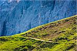 Hiking along the mountain trail at the Sella Pass in the Dolomites in South Tyrol, Italy