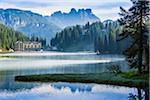 Grand Hotel Misurina with mist over Lake Misurina with the majestic mountain tops of the Dolomites in the background near Cortina d'Ampezzo, Italy