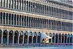 Cafe entrance and patio with empty seats on St Mark's Square at sunrise in Venice, Italy