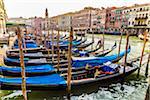 Station of gondola boats moored along the Grand Canal in Venice, Italy