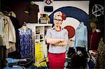 Portrait of quirky vintage mature woman in vintage clothes shop