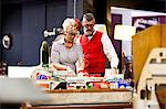 Quirky vintage couple looking at vinyl records in antique and vintage emporium