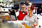 Quirky vintage couple shopping together in antiques emporium