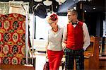 Quirky vintage couple shopping in antiques and vintage emporium