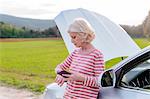 Female tourist with car breakdown waiting on rural roadside, Siena, Tuscany, Italy