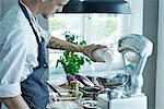 Male chef, weighing ingredients on vintage scales