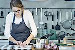 Chef placing filo pastry into baking tray