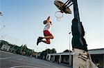 Man jumping for basketball hoop